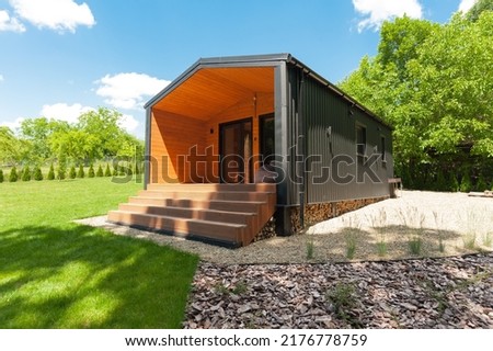 exterior of a suburban compact modular cabin for family vacations Royalty-Free Stock Photo #2176778759