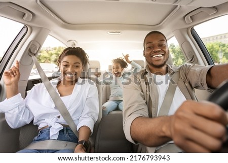 Black Family Riding Car Traveling Together In Summer, Smiling To Camera. Parents And Preteen Daughter Sitting In New Automobile. Auto Ownership And Purchase Concept. Selective Focus Royalty-Free Stock Photo #2176793943