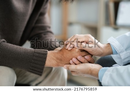 Male doctors shake hands with patients encouraging each other and praying for blessings. To offer love, concern, and encouragement while checking the patient's health. concept of medicine Royalty-Free Stock Photo #2176795859