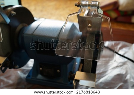 grinding machine. Sharpening machine for edge tools. A new machine for sharpening in blue and black colors.