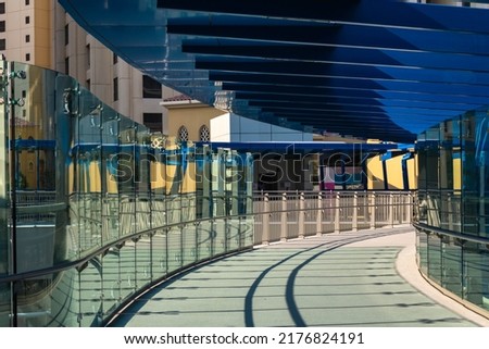 Blue pedestrian bridge on Dubai's Jumeirah Beach Residence Royalty-Free Stock Photo #2176824191