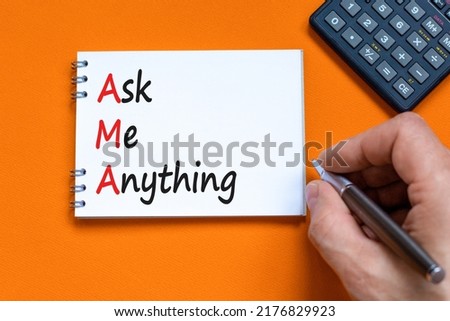AMA ask me anything symbol. Concept words AMA ask me anything on white note on a beautiful orange background. Businessman hand. Business and AMA ask me anything concept. Copy space.