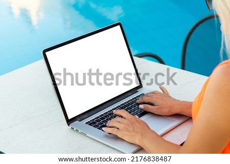 laptop with blank screen near the pool