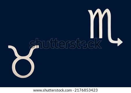 Astrological symbols on dark background. Complementary opposite signs: Taurus- Scorpio. Astrology. Astrological signs, earth and water elements. Taurus-Scorpio axis