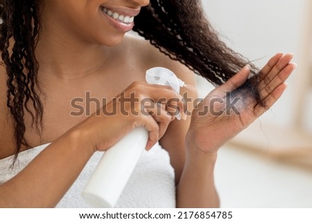 Haircare. Smiling Black Woman Applying Hair Spray To Split Ends, Young Happy African American Female Standing Wrapped In Towel After Shower Using New Hairstyle Product At Home, Closeup Shot Royalty-Free Stock Photo #2176854785