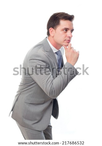 Young business man over white background. He looks interested