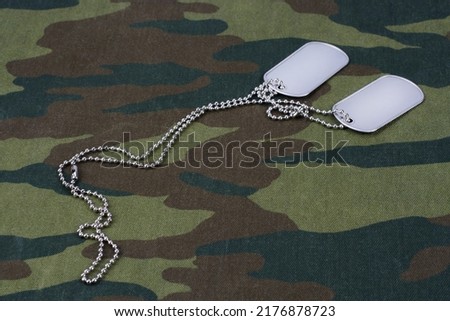 dog tags on russian camouflage uniform background