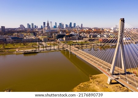 Panoramic view from drone of Warsaw modern cityscape on left bank of Vistula river with cable-stayed Swietokrzyski bridge in spring, Poland..