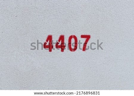 Red Number 4407 on the white wall. Spray paint.
