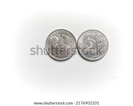 Top view photo front and back of Russian coins costing five rubles isolated on white background shot with light and shadow for decorative design.