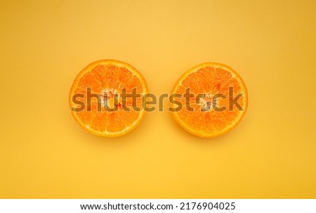 Top view of sliced oranges is over a yellow background. Healthy fruit concept. Close-up photo. Space for text
