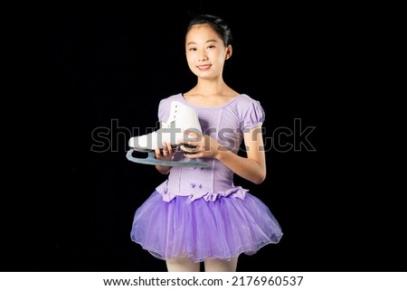 Asian girl holding skating shoes. Figure skater.