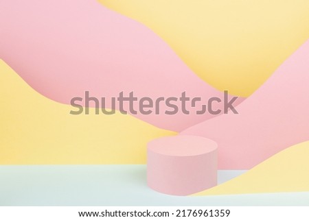 Circle pink podium mockup with abstract mountain landscape - colorful pastel pink, yellow, mint color slopes in baby cartoon naive style. Template for presentation of cosmetic, advertising, showing. 