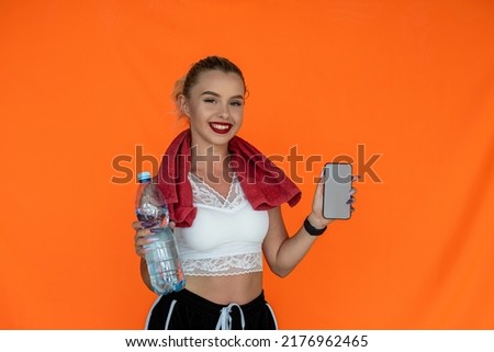 an incredibly beautiful girl with a slender figure drinks water and holds a bed mat on a similar background. Sport concept