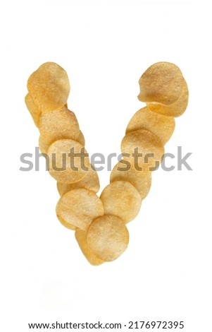 Capital letter V from potato crispy chips isolated on white background. Design element. Food lettering. Potato chips letter.