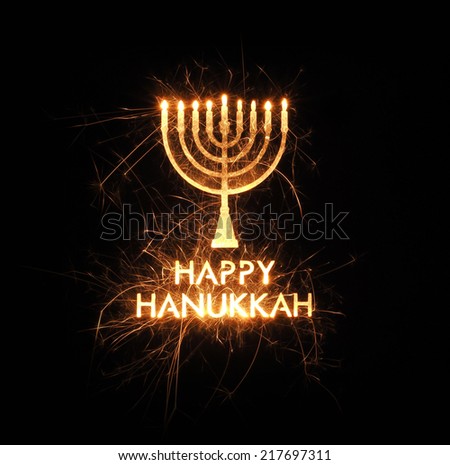 Hanukkah menorah greeting created with sparks on black background
