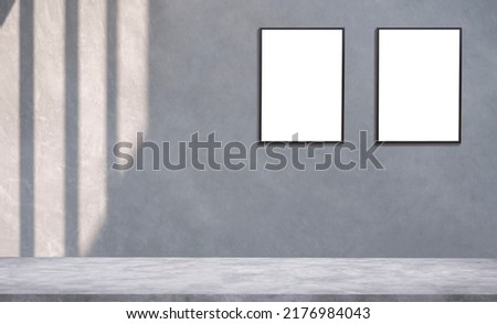 Background of light and shadow on surface of 2 blank picture frames on cement wall with concrete floor in loft style for editing products display and text present on free space backdrop