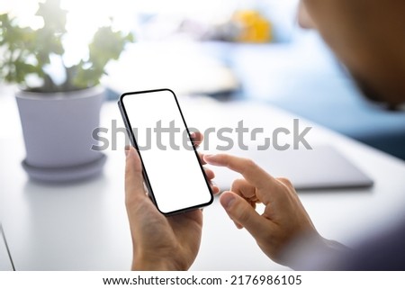 Man using smartphone blank screen frameless modern  - bright home interior