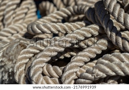 stack of twisted chain rope for sale,outside,outdoors market,store,shop.knot sailing rope thick nautical.close up macro photography texture. 