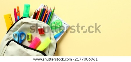 Backpack with school stationery on yellow background. School supplies sale banner. Back to school concept. Royalty-Free Stock Photo #2177006961