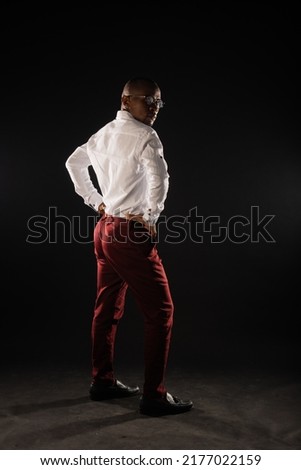 Africna black male is posing with his back in studio