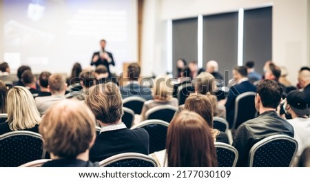 Speaker giving a talk in conference hall at business event. Rear view of unrecognizable people in audience at the conference hall. Business and entrepreneurship concept. Royalty-Free Stock Photo #2177030109