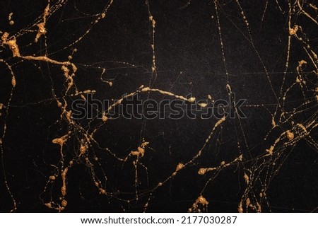 Gold and black marble art pattern. Textured abstract background.