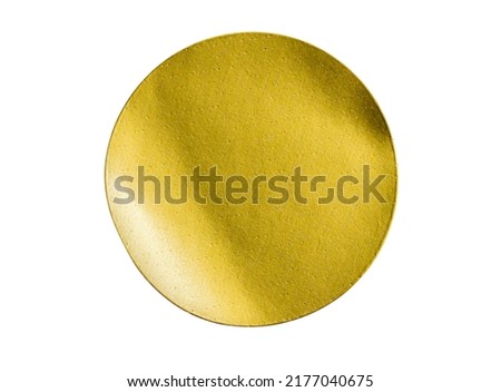 Blank golden round adhesive paper metallic sticker label isolated on white background