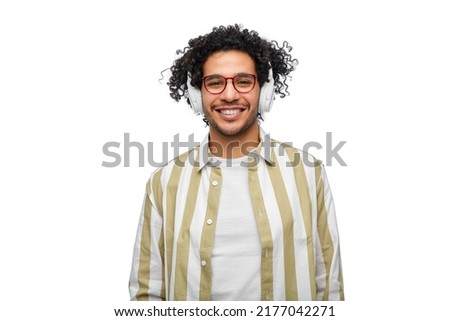 music, technology and people concept - happy smiling young man in headphones over white background