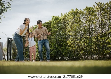 Family having Fun time at Home. Asian Family with little kids daughter playing together in house backyard outside. Happy family time. Royalty-Free Stock Photo #2177051629