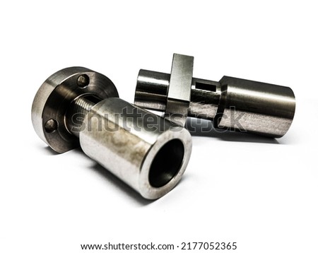 cylindrical cylinder with holes for screwing in steel, stainless steel, aluminum with a reflective silver coating 2 pieces placed side by side on a white background Royalty-Free Stock Photo #2177052365