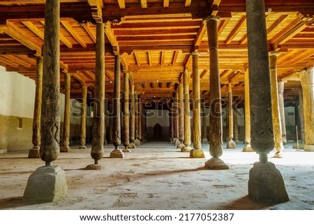 Rows of carved wooden columns in Juma Mosque, Khiva, Uzbekistan. Building was founded in 10th century. Special detail is that none of columns are similar to other Royalty-Free Stock Photo #2177052387