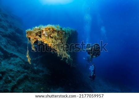 A scuba diver explores an old, sunken shipwreck in the Aegean Sea, Kea island, Greece  Royalty-Free Stock Photo #2177059957