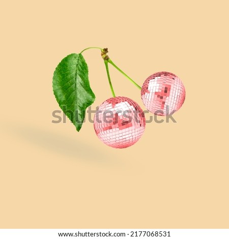 Unusual combination of usual things. Red cherries as a disco balls flying on beige background. Modern design. Copy space. Contemporary art. Collage made out of red cherries and disco balls. Royalty-Free Stock Photo #2177068531