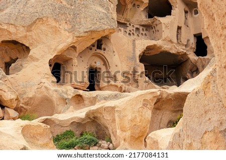 From below close-up shot of cave dwellings of Cappadocia, Goreme National Park of Nevsehir, Turkey. Cave house architectures of Cappadocia. Outdoor, travelling concept. Royalty-Free Stock Photo #2177084131