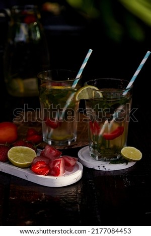 Summer infused water with lemon, lime, mint and strawberries. Refreshing, diet, detox natural fortified water. Hard seltzer with nootropics. Healthy natural cocktails. Summertime beverages. Royalty-Free Stock Photo #2177084453