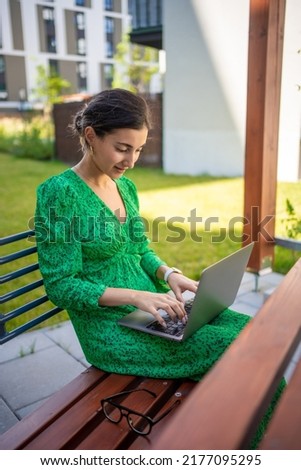 Caucasian woman working with laptop computer outside office. High quality photo