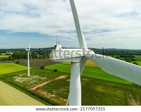 Close up aerial view of a wind turbine in a small rural wind farm in the English countryside Royalty-Free Stock Photo #2177097355