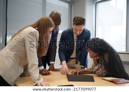 Business people discussing documents and ideas at meeting, Business people in the workplace are discussing a working strategy for doing business