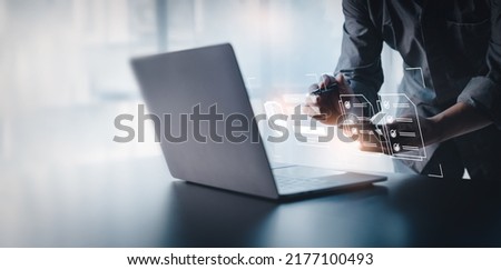 Businessman working on a laptop computer to document management online documentation database digital file storage system software records keeping database technology file access doc sharing. Royalty-Free Stock Photo #2177100493