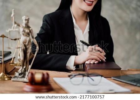 Asian lawyer woman working with a laptop computer in a law office. Legal and legal service concept. Looking at camera Royalty-Free Stock Photo #2177100757