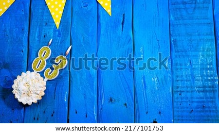 Top view copy space background festive on vintage blue boards with pie and decorations. Background congratulations on your birthday with a number from a candle with a number 83