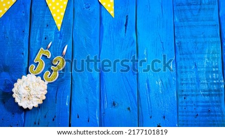 Top view copy space background festive on vintage blue boards with pie and decorations. Background congratulations on your birthday with a number from a candle with a number 53.