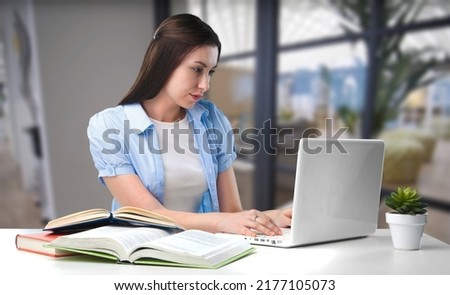 Business woman sit at table make correction in document, check data, student prepare essay, learn at home use tech concept