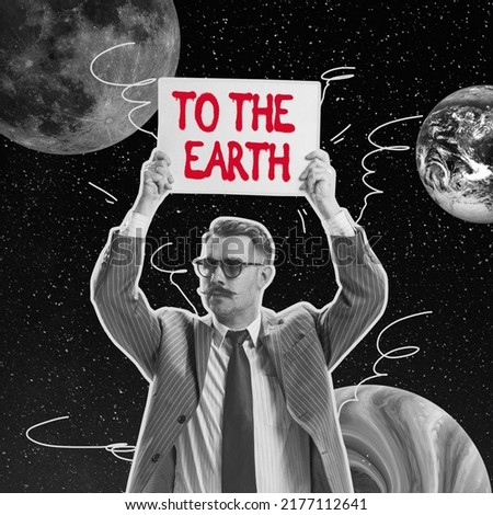 Come back home concept. Serious man holding sign over his head isolated over dark space with planets background. Concept of modern world, immigration, brain drain, refugees