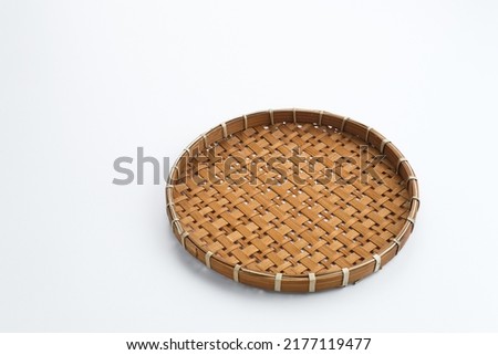 Traditional wicker plate made of bamboo isolated on a white background. Copy space. Royalty-Free Stock Photo #2177119477