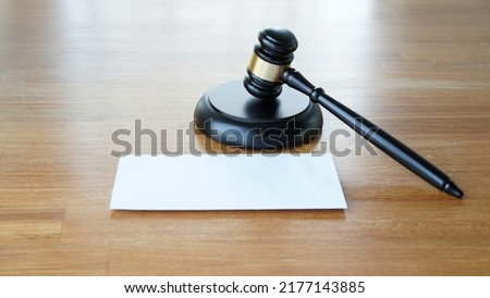 Lawyer or judge's hammer in the court. Auction's hammer is on woo table. Law subject. Judgement subject to judge people.