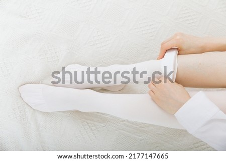 Anti-embolic Compression Hosiery for surgery isolated on white. Medical white stockings, tights for varicose veins and venouse therapy. Thrombo embolic deterrent hose or anti-embolism stockings. Royalty-Free Stock Photo #2177147665