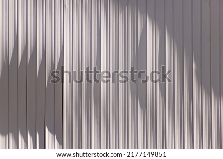 Damaged segments of plastic lining shades of whiteand gray. Texture or background