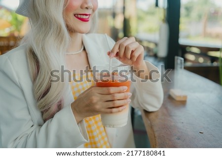 Beautiful woman holding Thai tea.